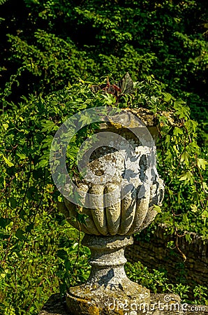 Concrete flower pots in the garden on a pedestal stylized antique, a place of rest, practical urban Stock Photo