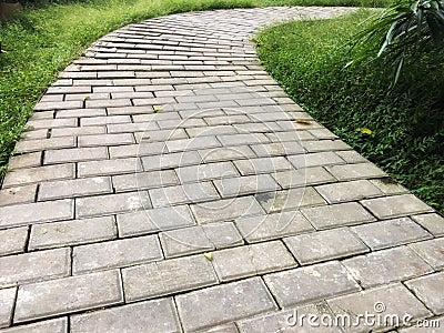 Concrete footpath arrangement by curve in the garden. Stock Photo