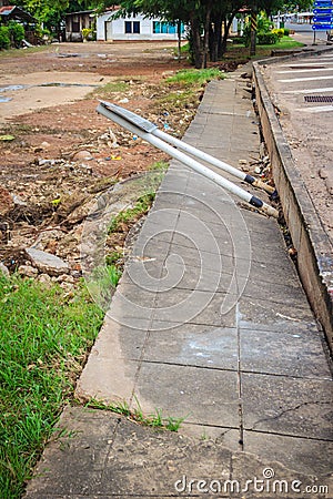 Concrete footpath is slipping after flood. Flood is causing eros Stock Photo