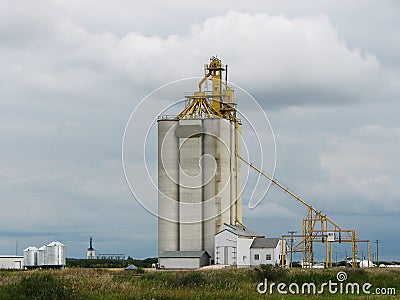 Concrete Grain Elevator with Cloudy Sky on Prairie Stock Photo