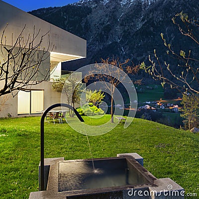 Concrete house with stone fountain Stock Photo