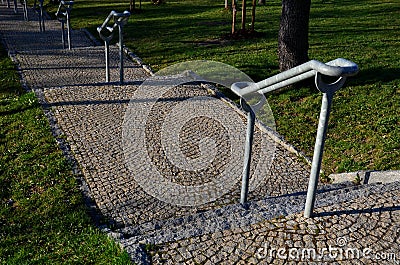 Concrete long staircase with long and short pieces of stairs and ramps made of cobblestone granite paving blocks. packing short ga Stock Photo