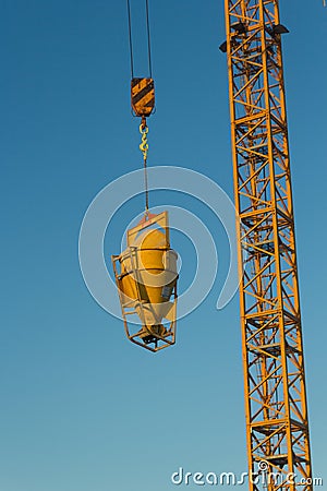Concrete machine for spreading cement hoisted at building site Stock Photo
