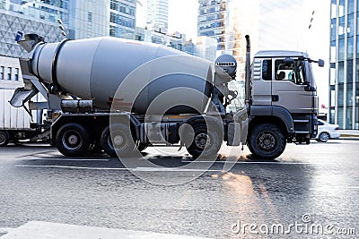 concrete mixer truck on city street. Side view of MAN TGA cement mixer driving on urban highway Editorial Stock Photo