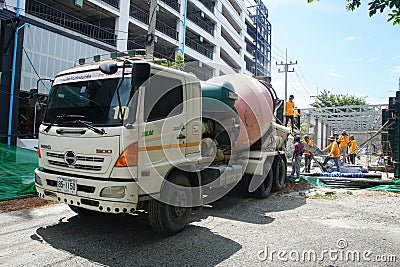 Concrete mixer truck are loading mortar to pour concrete columns for workers on construction site. Editorial Stock Photo