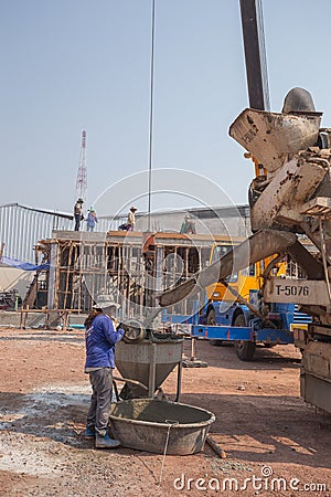 Concrete mixer truck pouring cement at construction site Editorial Stock Photo