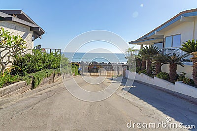 Concrete pathway heading to the gate exit with garden beds on the side in San Clemente, California Stock Photo