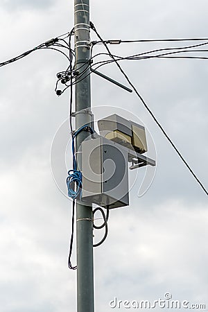 Concrete pole with electrical wires and communication equipment Stock Photo