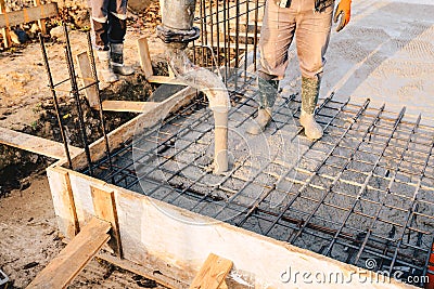 Concrete pouring during commercial concreting floors of building Stock Photo