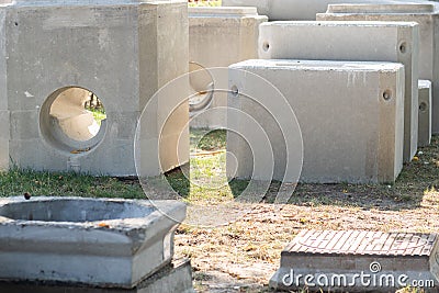 Concrete prefabric elements lying on the ground, ready for sewerage, sewage system imrovement in big city. Infrastructure developm Stock Photo