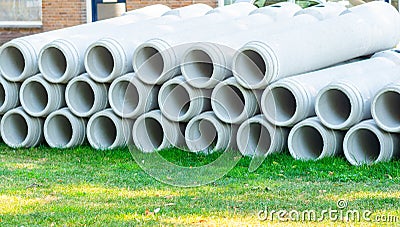 Concrete prefabric elements lying on the ground, ready for sewerage, sewage system imrovement in big city. Infrastructure developm Stock Photo