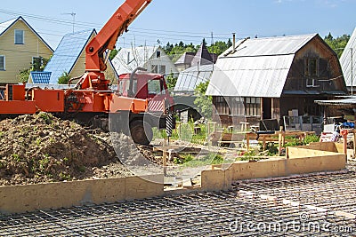 Concrete pump in anticipation of pouring concrete in a prepared Stock Photo