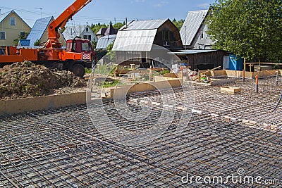 Concrete pump in anticipation of pouring concrete in a prepared Stock Photo