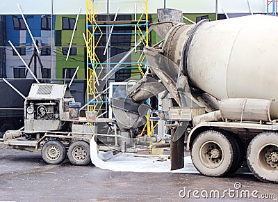 concrete pump and mixer to work together pouring cement floors in the shopping center for repair. Stock Photo