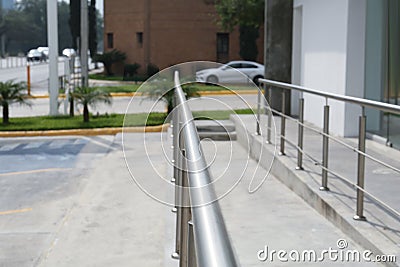 Concrete ramp with metal handrail near building outdoors, closeup Stock Photo