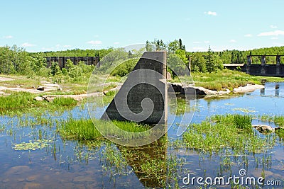 Concrete remains of a destroyed Pinawa Dam standing in the water. Stock Photo