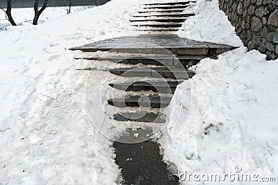 Concrete stone staircase covered with dirty deep slippery snow after blizzard snowstorm snowfall at city pedestrian Stock Photo