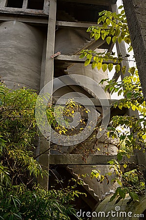 Concrete storage tower with stairways of abandoned fertilizer plant Stock Photo