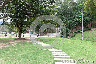 Concrete tile walkway in lawn at city park garden ,Outdoor cement brick tiled road Stock Photo