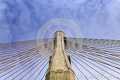 Concrete tower and cable bridge with cloud and blue sky Stock Photo