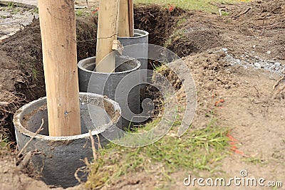 Concrete tube fundament with wood column Stock Photo