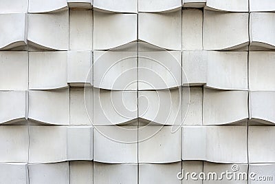 A concrete wall with sharp, symmetrical lines. Embossed areas create a textured effect Stock Photo