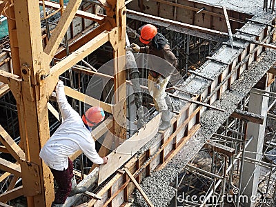 Concreting work by construction workers at the construction site. Editorial Stock Photo