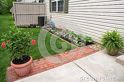 Condo Back Flower Garden with Red Brick Pavers Stock Photo