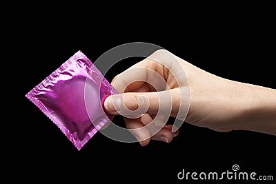 Condom in hand Stock Photo