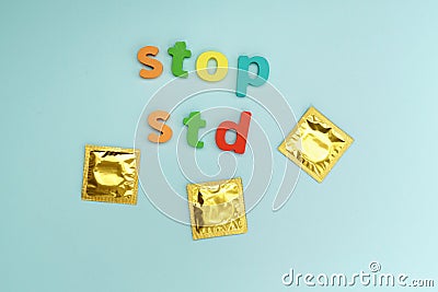 Condoms STOP STD text on blue background. Safe sex concept. Healthcare concept, world AIDS day. Flat lay Stock Photo
