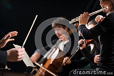 Conductor directing symphony orchestra Stock Photo