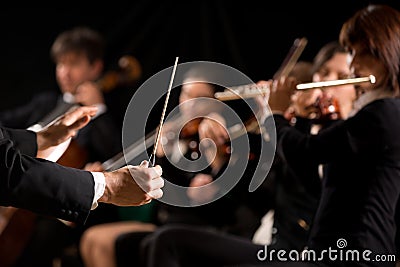 Conductor directing symphony orchestra Stock Photo