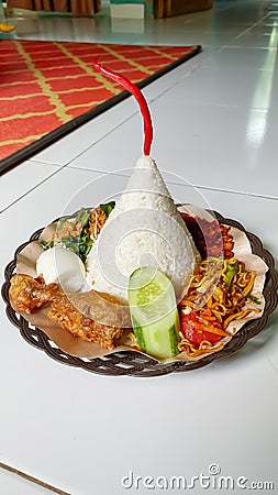 Cone-shaped Rice with Chicken, Fried Noodles, Tofu Chili, Vegetables, and Cucumber Fillings Stock Photo