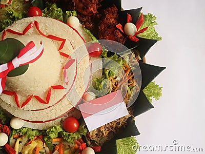 Cone Shaped Rice with Indonesian National Ribbon called Nasi Tumpeng Merah Putih For Independence Day Celebration at 17 August Stock Photo