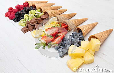 Cone waffle with fresh fruit and chocolate, homemade ice cream making Stock Photo