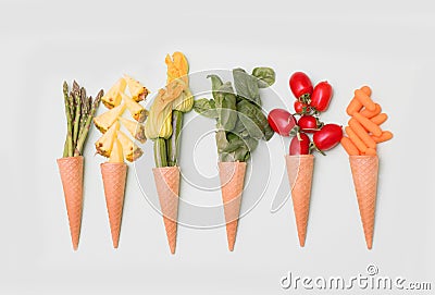 Cone waffle with pineapple slices, zucchini`s flower,basil,tomatoes and baby carrot Stock Photo