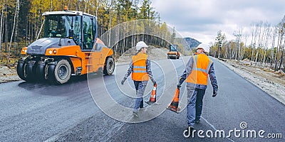 Cone worker asphalting Stock Photo