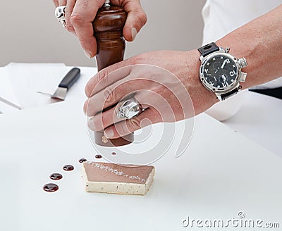 Confectioner putting salt on dessert Stock Photo