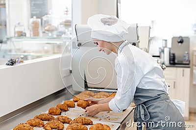 Confectioner woman baking pastry roles and chocolate bread Stock Photo