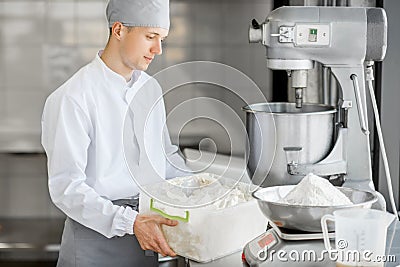 Confectioner working at the bakery manufacturing Stock Photo