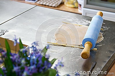 Confectioner works with dough on a table in a pastry shop, cuts out forms Stock Photo