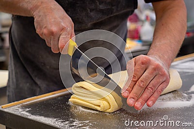 Confectioner works the puff pastry dough, artisan, gourmet Stock Photo