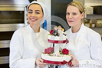 Confectioners or bakers presenting wedding cake Stock Photo