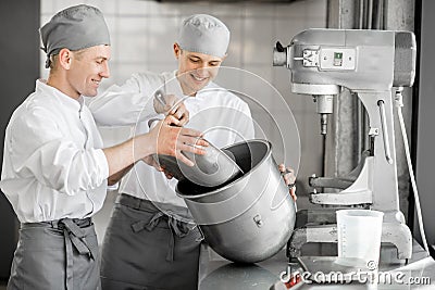 Confectioners working at the bakery manufacturing Stock Photo