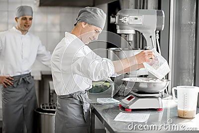 Confectioners working at the bakery manufacturing Stock Photo