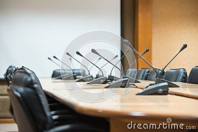 Before a conference, the microphones in front of empty chairs. Stock Photo