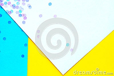 Confetti on abstract geometric paper background, festive concept. Stock Photo