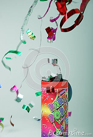 Confetti shooting from a party popper Stock Photo