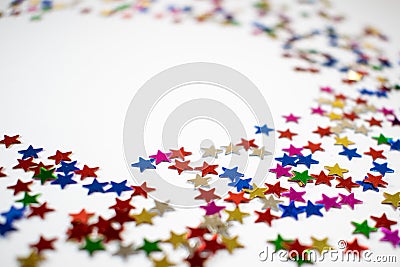 Confetti stars on white background, festive colorful and shiny stars on white background with copy space Stock Photo