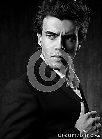 Confident ambitious handsome man with strained look posing in fa Stock Photo